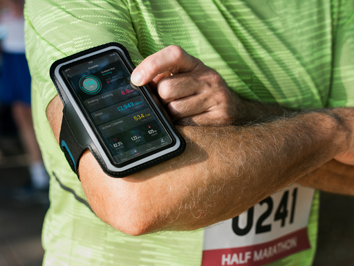 PLEASE DO NOT USE: DUP_GO-Health law-runner with smartphone-shutterstock_1097634593